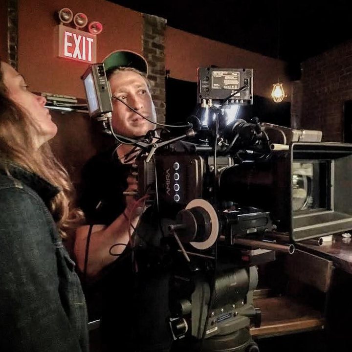 Brandon operating an ARRI Amira on a bar set